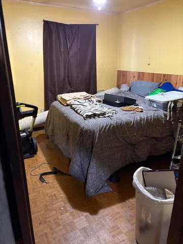 a bedroom with a bed and a chair