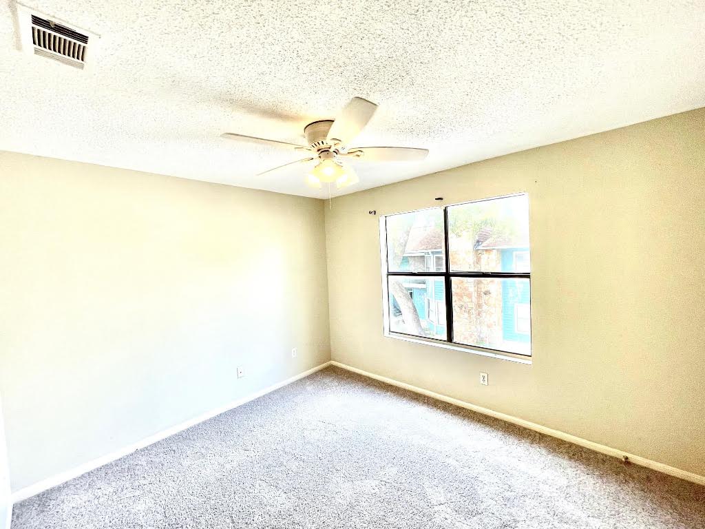 8811 Schick Road, Unit C Austin, TX 78729 - Photo 5 of 10 a view of an empty room with a window