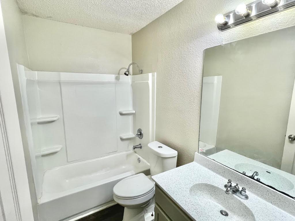 8811 Schick Road, Unit C Austin, TX 78729 - Photo 8 of 10 a bathroom with a sink toilet and shower