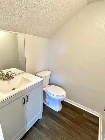 a white toilet sitting next to a bathroom sink