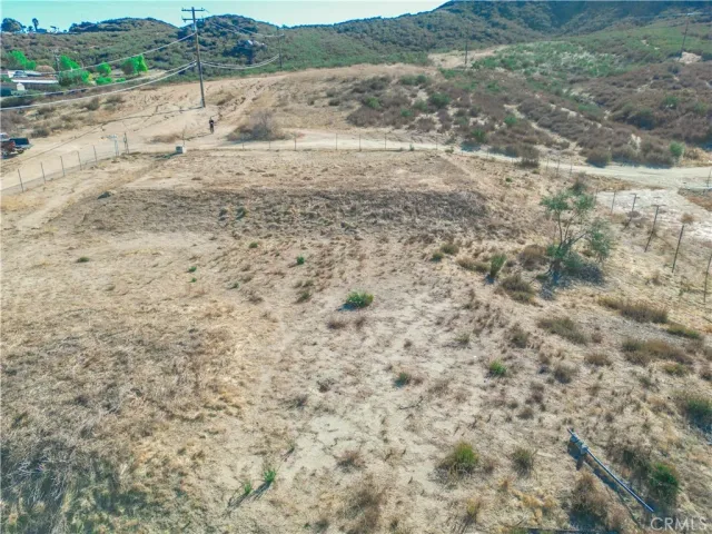 a view of a dry field with trees