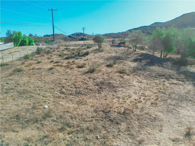 a view of a road with a house in the background