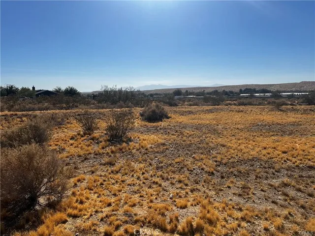 a view of a lake with houses in the back