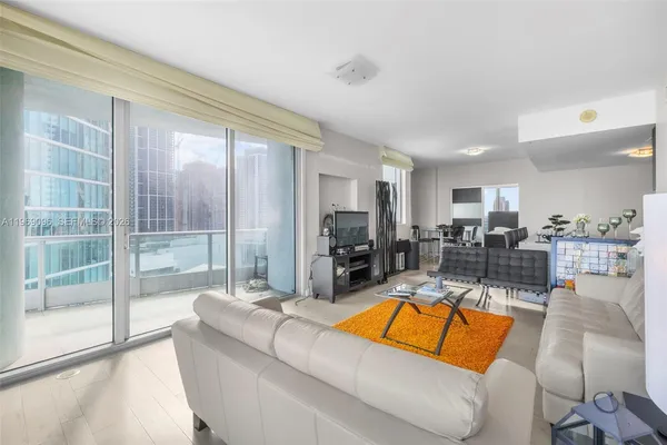 a view of a living room kitchen and a large window