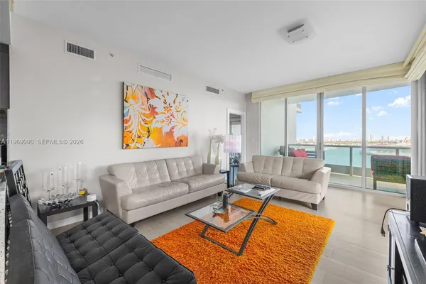 a living room with furniture or couch and a large window
