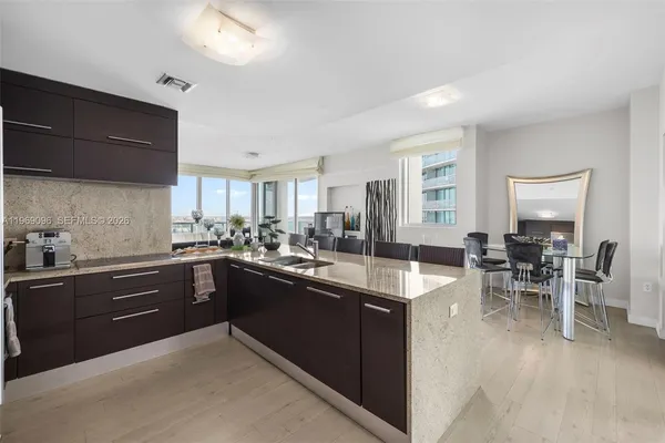 a kitchen with lots of counter top space and dining table