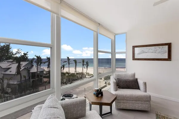 a living room with furniture and a floor to ceiling window