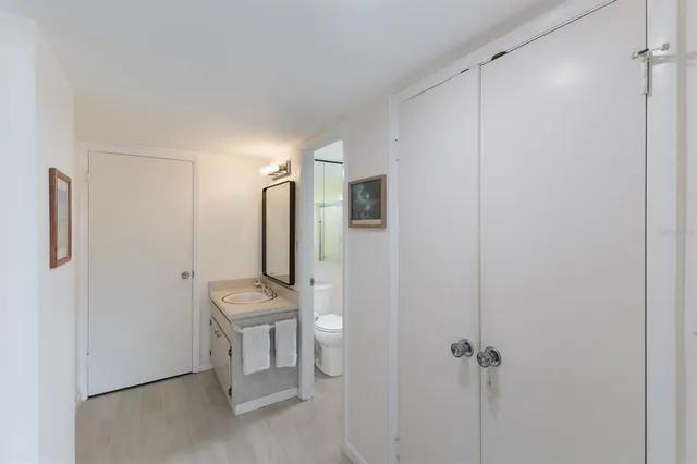 a bathroom with a sink toilet and a mirror