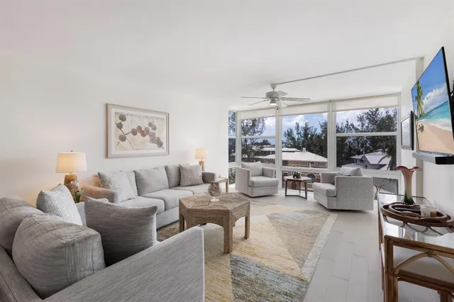 a view of a livingroom with chairs and table