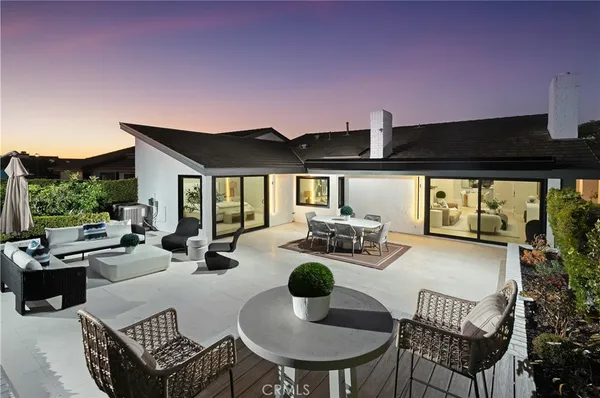a view of a patio with couches chairs and a potted plant