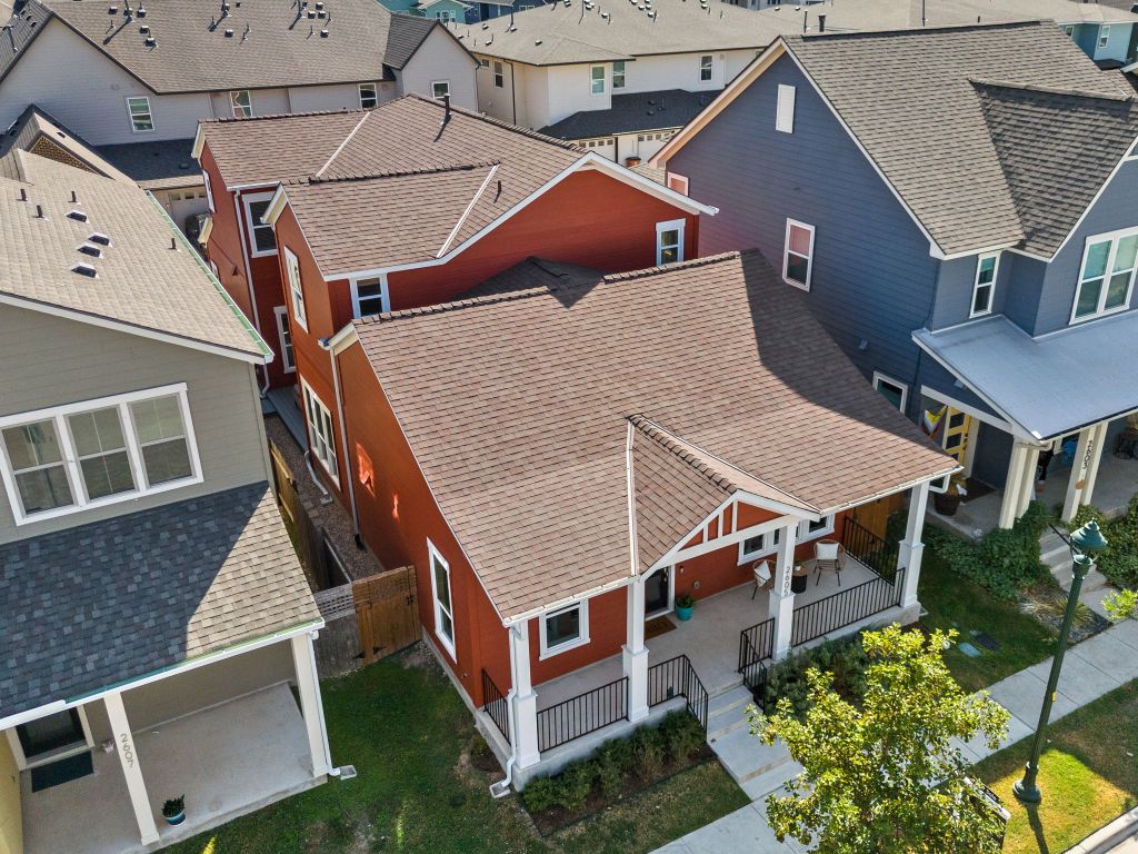 an aerial view of a house with a yard