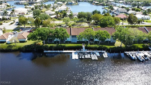 an aerial view of a house with swimming pool patio and lake view