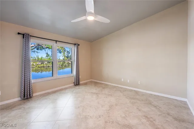 an empty room with windows and balcony