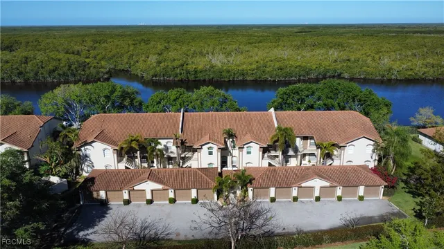 an aerial view of house with outdoor space and lake view