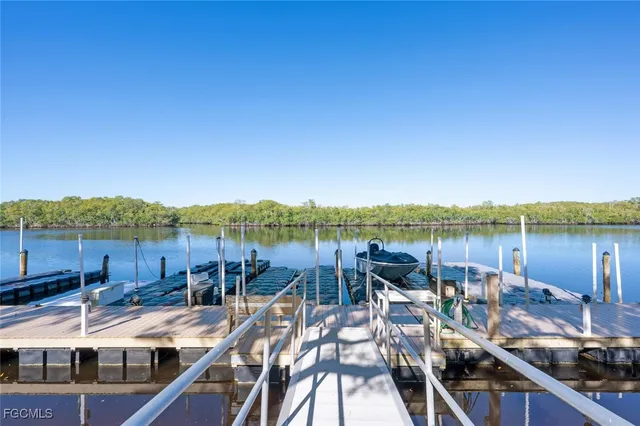 a view of a lake with couches and wooden floor