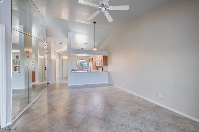 a view of a big room with wooden floor and a kitchen
