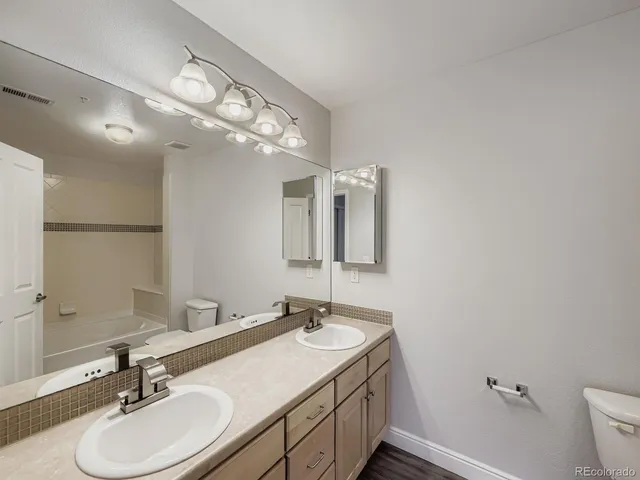 a bathroom with a sink double vanity and a mirror