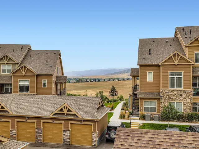 a front view of a house with a garden and plants