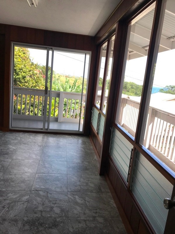 744 A Wainaku Street Hilo, HI 96720 - Photo 22 of 23 a view of an empty room with wooden floor and a window
