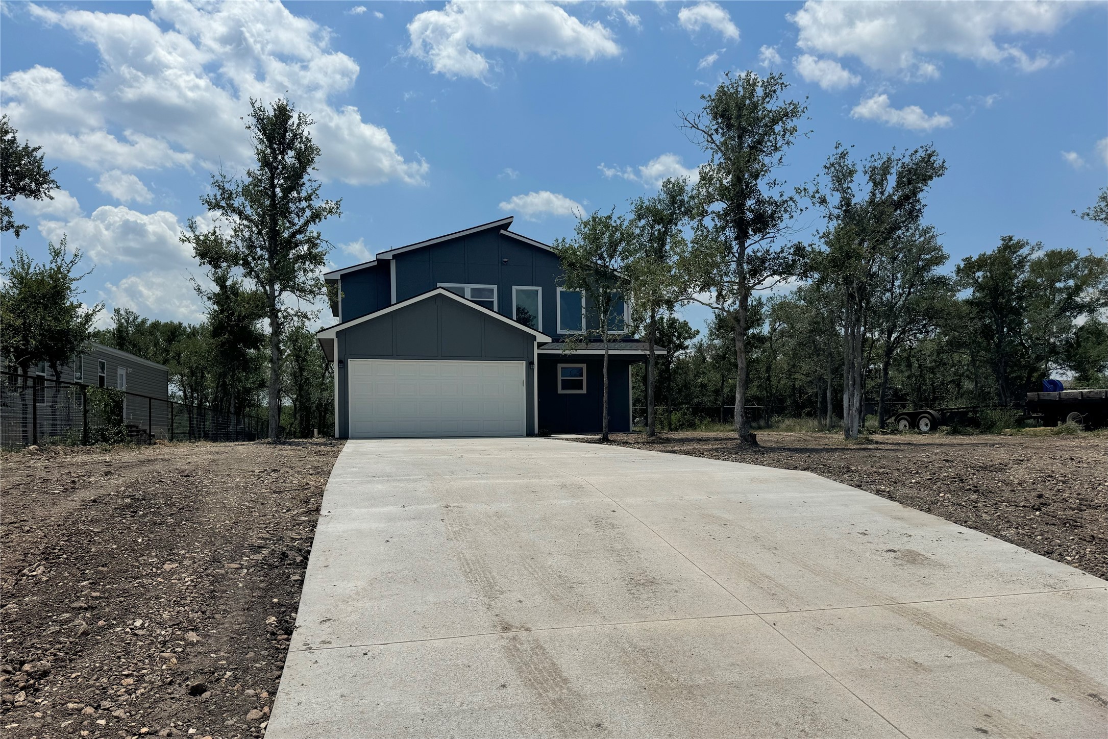 128 Passion Vine Rd Dale Dale, TX 78616 - Photo 1 of 1 a front view of a house with a yard and garage