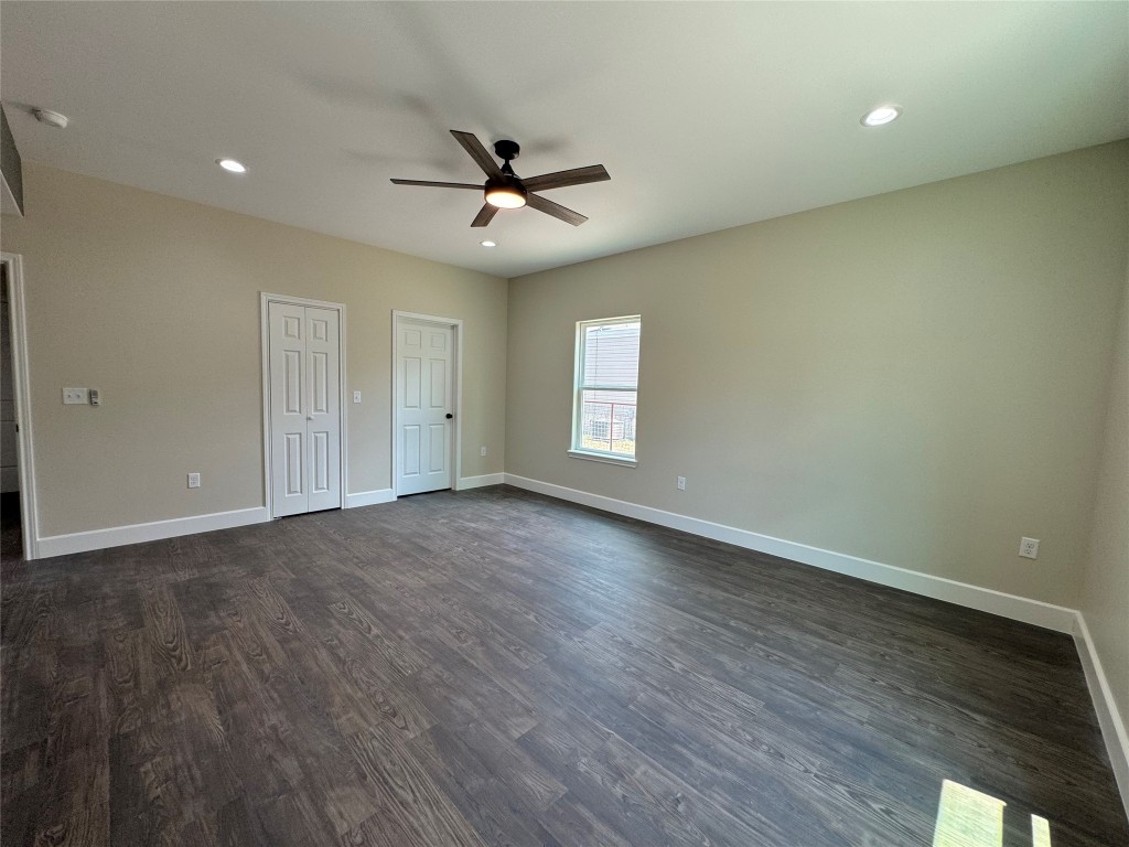 128 Passion Vine Rd Dale Dale, TX 78616 - Photo 11 of 30 an empty room with wooden floor fan and windows
