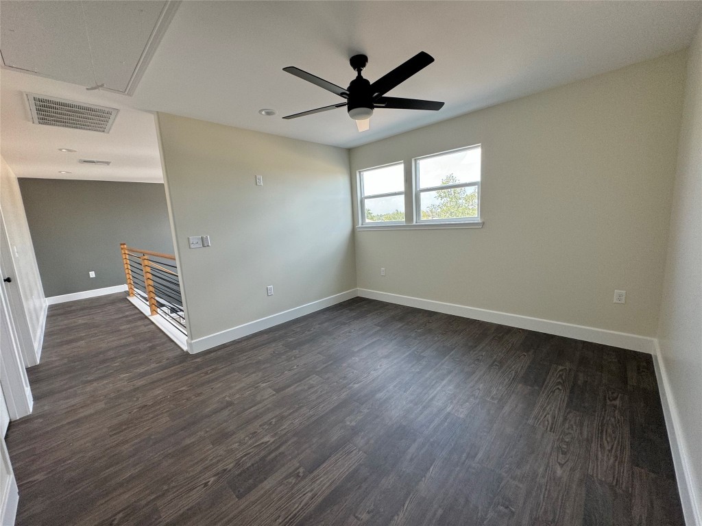 128 Passion Vine Rd Dale Dale, TX 78616 - Photo 17 of 30 an empty room with wooden floor a ceiling fan and windows