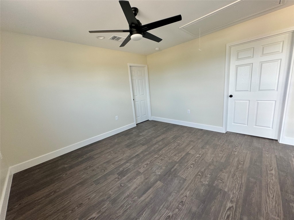 128 Passion Vine Rd Dale Dale, TX 78616 - Photo 19 of 30 a view of a room with wooden floor and a ceiling fan
