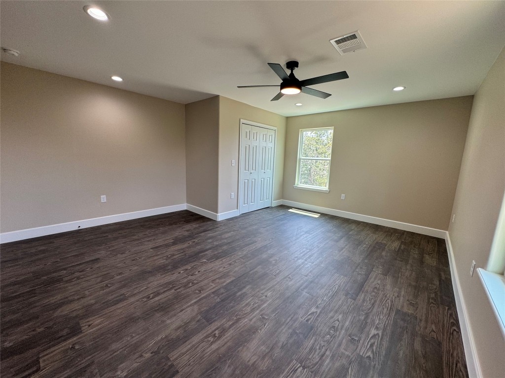 128 Passion Vine Rd Dale Dale, TX 78616 - Photo 23 of 30 a view of empty room with wooden floor and fan