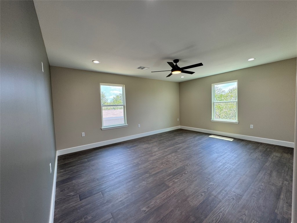 128 Passion Vine Rd Dale Dale, TX 78616 - Photo 25 of 30 an empty room with wooden floor and windows
