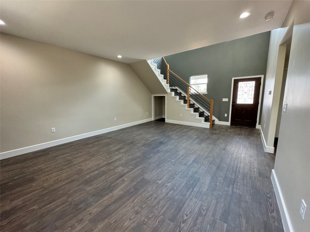 128 Passion Vine Rd Dale Dale, TX 78616 - Photo 6 of 30 an empty room with wooden floor and windows