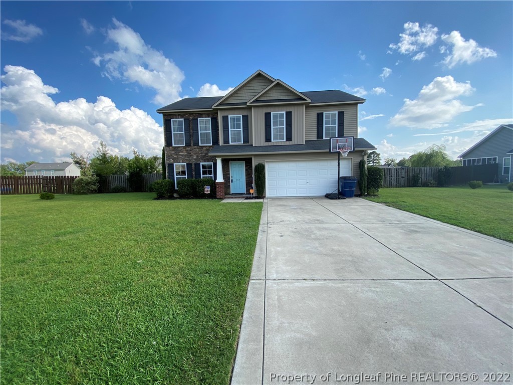 269 Declaration Drive Raeford, NC 28376 - Photo 1 of 26 a front view of a house with garden