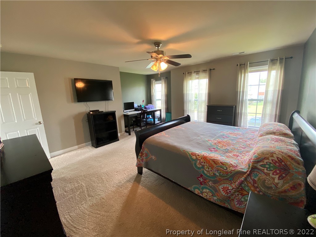 269 Declaration Drive Raeford, NC 28376 - Photo 11 of 26 a bedroom with a bed and a flat screen tv