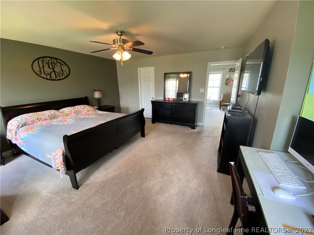 269 Declaration Drive Raeford, NC 28376 - Photo 12 of 26 a bed room with a bed mirror and a window