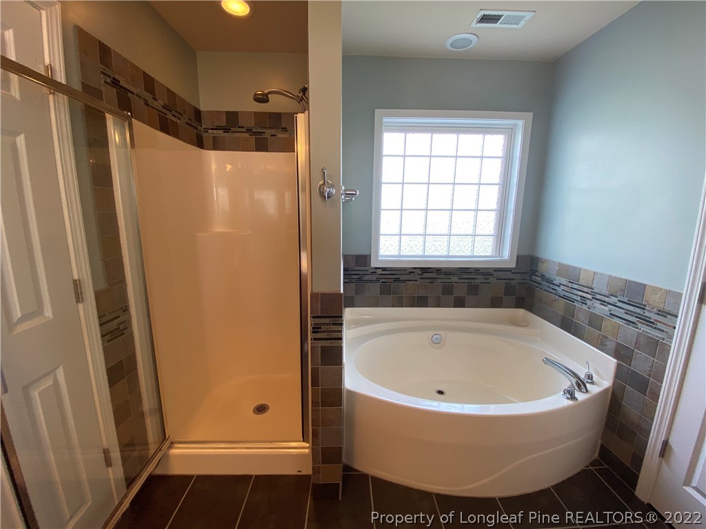269 Declaration Drive Raeford, NC 28376 - Photo 14 of 26 a bathroom with bathtub and window