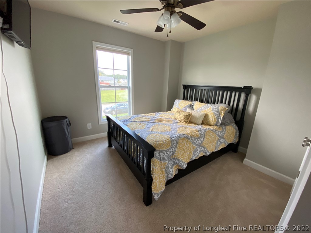 269 Declaration Drive Raeford, NC 28376 - Photo 18 of 26 a bed sitting in a bedroom next to a window