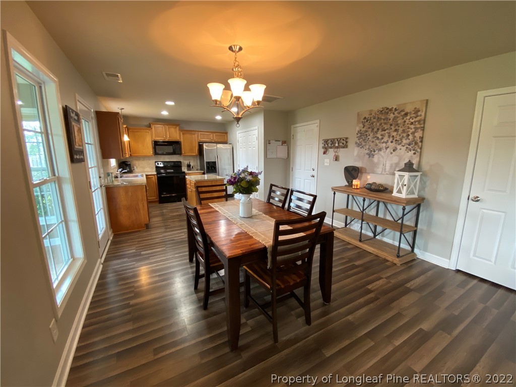 269 Declaration Drive Raeford, NC 28376 - Photo 3 of 26 a view of a dining room with furniture and wooden floor