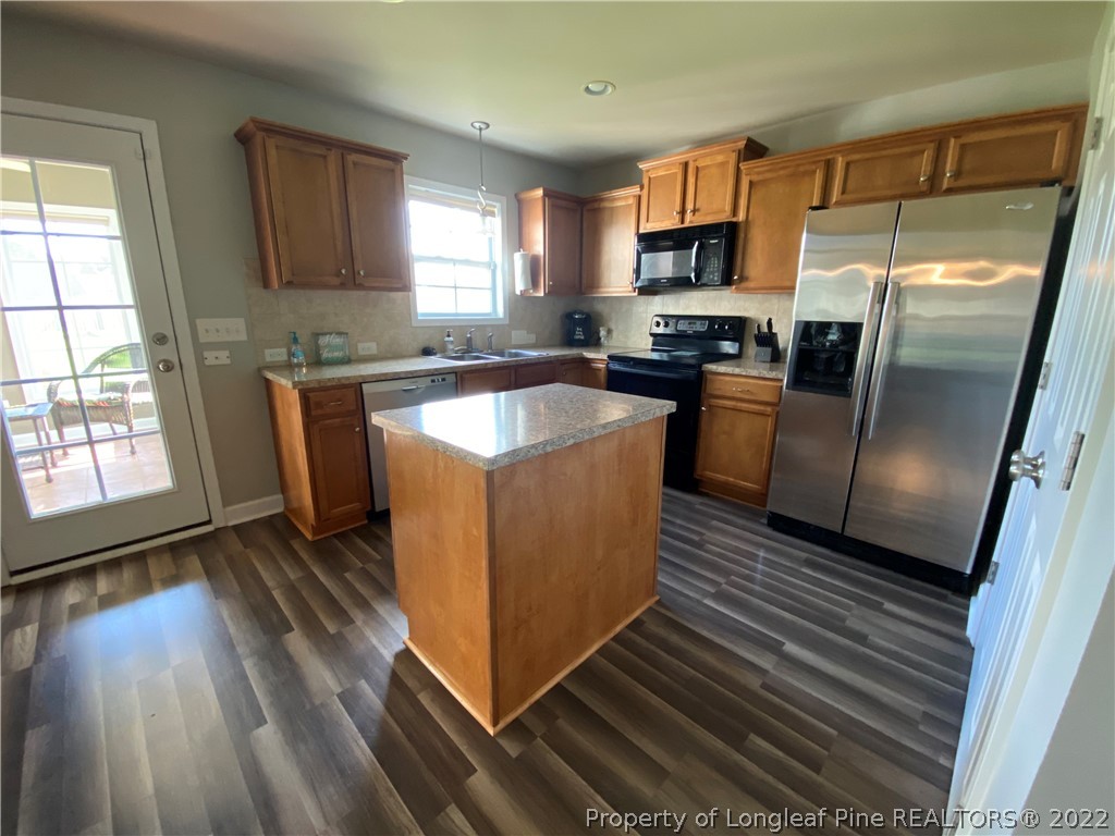 269 Declaration Drive Raeford, NC 28376 - Photo 6 of 26 a kitchen with wooden floors and stainless steel appliances
