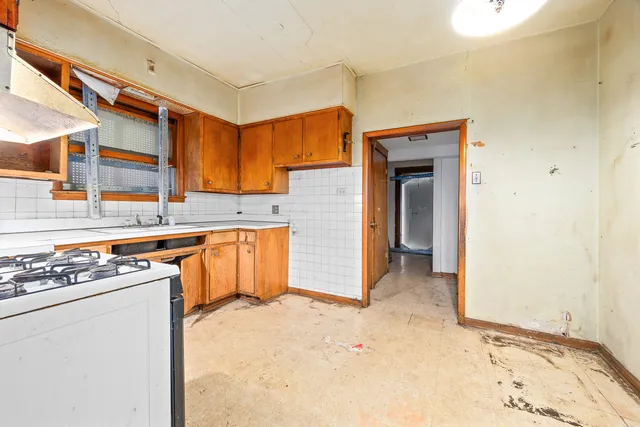 a view of a kitchen with wooden floor and electronic appliances