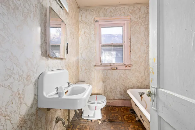 a bathroom with a sink a toilet and a bathtub