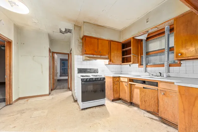a kitchen with stainless steel appliances granite countertop a stove and a sink