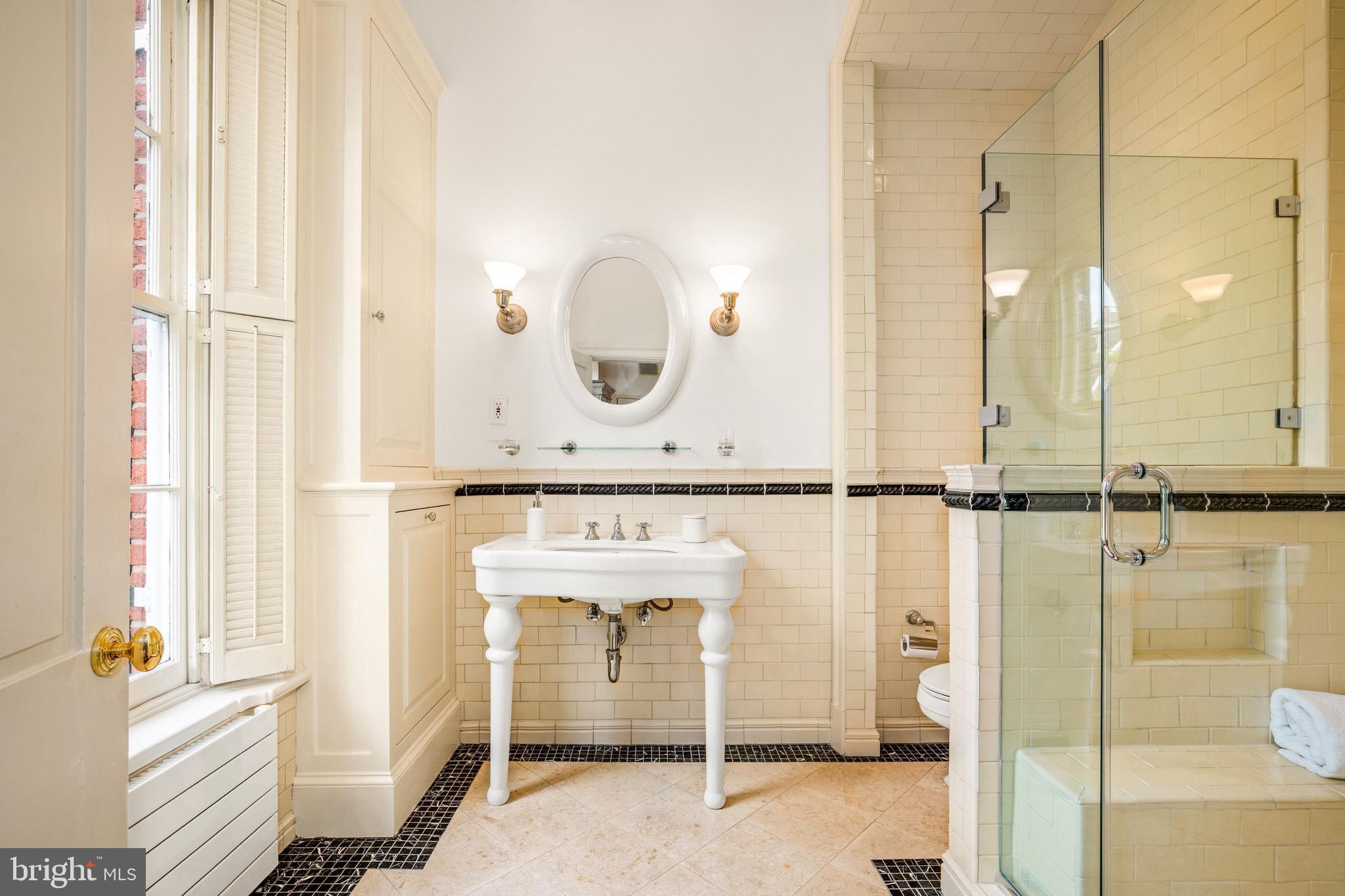 3316 N Street Northwest Washington, DC 20007 - Photo 12 of 18 a bathroom with a mirror and a shower