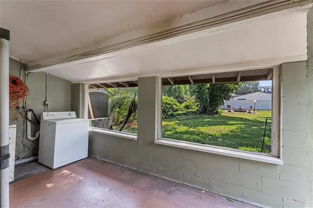 a view of a porch with furniture and floor to ceiling window