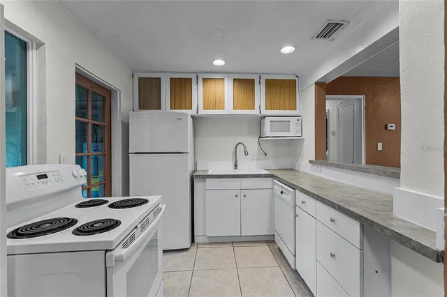 a kitchen with a sink stove and refrigerator