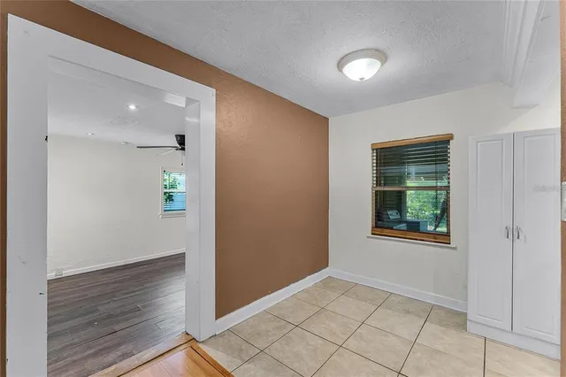 an empty room with windows and entrance