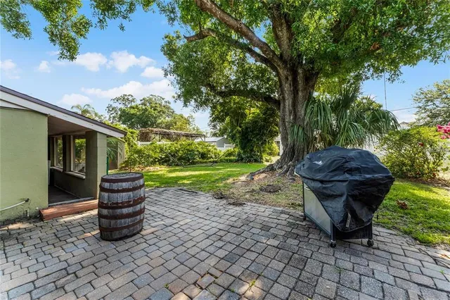 a view of a back yard with a table and chairs
