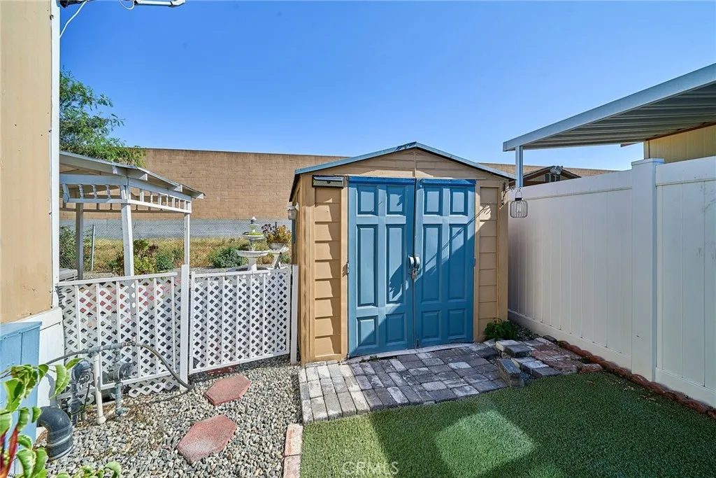 4000 Pierce Street, Unit 168 Riverside, CA 92505 - Photo 22 of 34 a view of a wooden house with a small yard and wooden fence