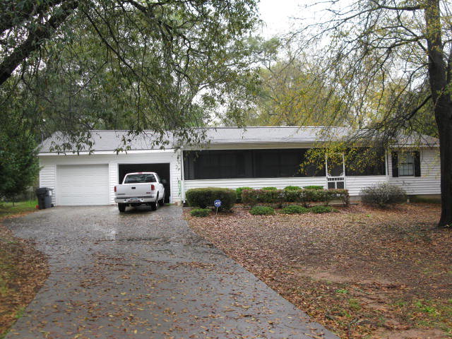 a view of a house with a yard and garage