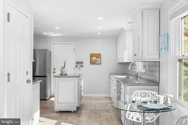 a kitchen with stainless steel appliances granite countertop a refrigerator and a stove top oven