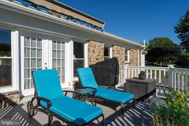 a balcony with furniture and umbrella