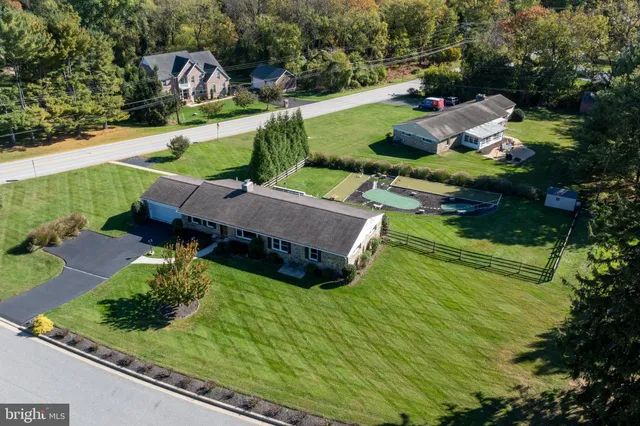 an aerial view of a house with yard swimming pool and outdoor seating
